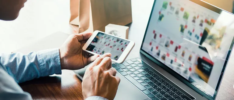 Hands reviewing an interface design on a tablet.